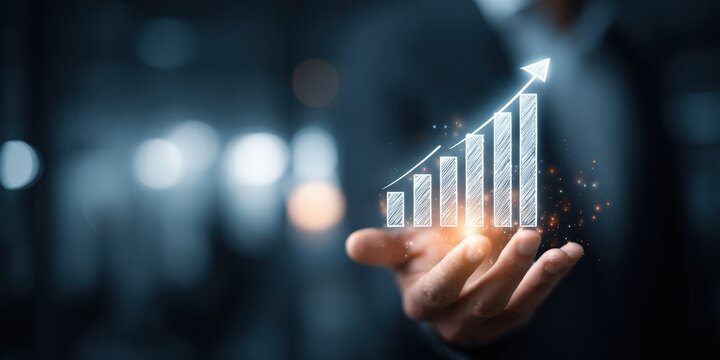 A person's hand gracefully cradles a luminous graph, an emblem of growth and progress against a bokeh background, representing success. ..Created with Generative AI, not depicting real subjects.