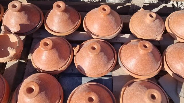 Handcrafted Moroccan tagines made of kiln-fired clay, showcasing traditional craftsmanship and cultural heritage. Commonly used in Moroccan cuisine, these rustic ceramics blend art and utility.