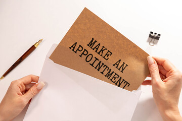 Hand with pen writing Make an appointment