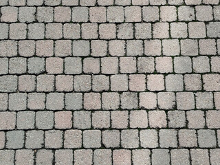 Fondo de pavimento de adoquines cuadrados en patrón de mosaico con colores gris y beige