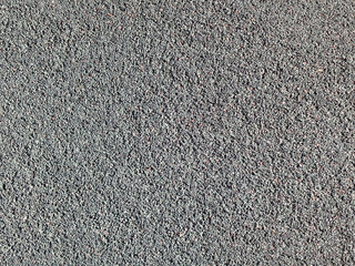 Fondo de textura granular y rugosa de pequeños gránulos en tono gris oscuro