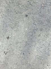Fondo de textura vertical de primer plano de asfalto gris claro o pavimento de grano fino