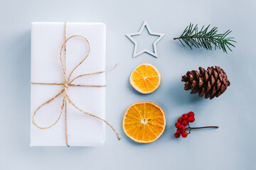 Collection of Christmas objects - gift box, frame, eve fir, dried orange, pine cone, star. New Year and winter minimal holiday frame composition. Flat lay, top view, place for text.