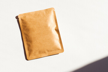 Blank craft plastic pouch, white pack on studio background with shadow, mylar bag isolated for coffee or food, cosmetic products, snack, candy. Different sizes, mock up.