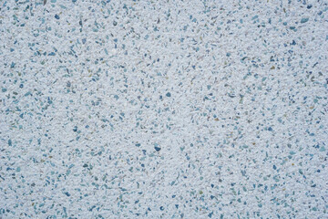 light blue-grey terrazzo texture closeup with small colorful embedded stone chips showing speckled pattern concept of construction material, architecture, flooring