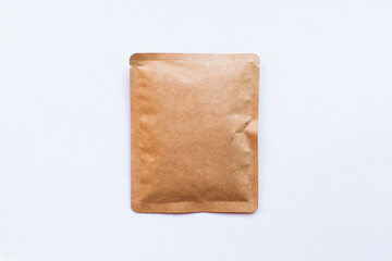 Blank craft plastic pouch, white pack on studio background with shadow, mylar bag isolated for coffee or food, cosmetic products, snack, candy. Different sizes, mock up.