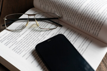 An open book with eyeglasses