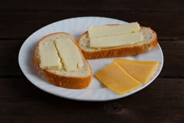 Sandwiches with butter on white plate