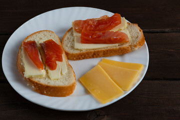 Sandwiches with butter and red fish on white plate