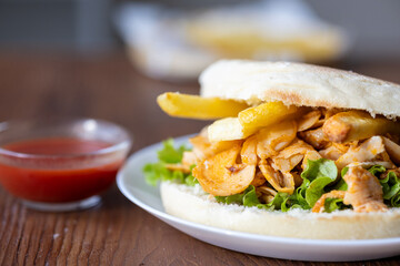Close-Up of Turkish Chicken Doner Served with French Fries in Bread
