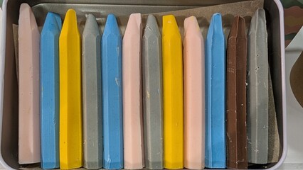 Pastel taper candles on tray stylist tabletop display