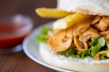 Close-Up of Turkish Chicken Doner Served with French Fries in Bread