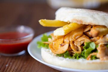 Close-Up of Turkish Chicken Doner Served with French Fries in Bread