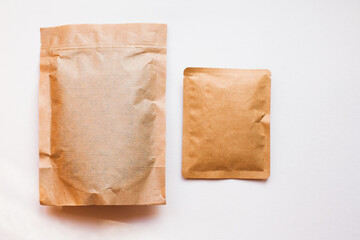 Blank craft plastic pouch, white pack on studio background with shadow, mylar bag isolated for coffee or food, cosmetic products, snack, candy. Different sizes, mock up.