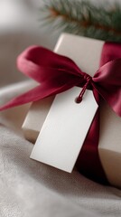 A stylishly wrapped present for a celebration, featuring a satin bow and a customizable label for personalized holiday or wedding messages.