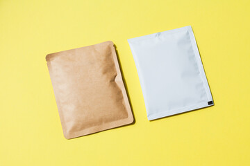 Blank craft plastic pouch, white pack on studio background with shadow, mylar bag isolated for coffee or food, cosmetic products, snack, candy. Different sizes, mock up.