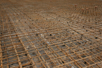 Tied rebar grid prepared for a building foundation, ready for concrete pouring at a construction...