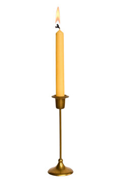 Tall slim brass candle holder and a lit taper candle, isolated on a transparent background