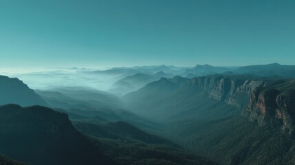 Breathtaking Landscape of Rolling Mountains Under Soft Blue Sky with Mist Shrouding Valleys and Thrilling Depths of Nature's Majestic Beauty