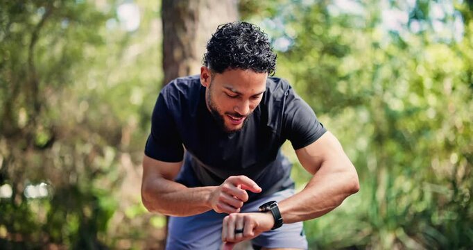Running, smart watch and tired with man in nature for tracking speed, fitness and workout performance. Sports athlete, timer and training with person outdoor for exercise, cardio challenge and rest