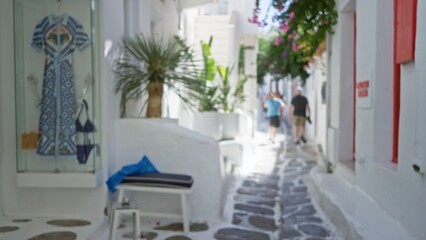 Sunlit whitewashed alley with stone pavement, potted plants and distant doorway, soft defocused bokeh alley; background backdrop copyspace calm.