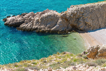 Scenic rocky coastline overlooking turquoise sea in sunlit summer