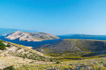Serene landscape of krk island with clear blue sky and rolling hill. View of Prvic island, Croatia