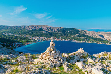 Scenic coastal view with rocky outcropping and mountainous landscape. Baška, Krk island, Croatia