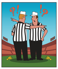 Two referees have a discussion after a penalty.