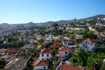 Fototapeta premium Aerial Car View Over Madeira Island, Distant Cityscape, Lush Mountains