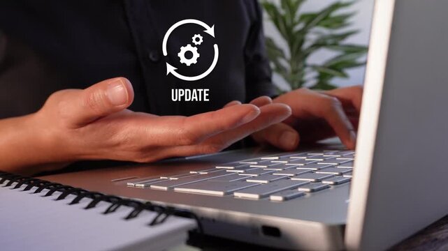 Software and system update. Close-up of a businesswoman's hands working on her laptop while holding an "Update" animation with gears and arrows.