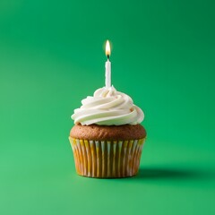 A delicious cupcake with white frosting and a lit birthday candle on top, set against a vibrant green background for celebration or special occasion themes