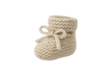 Cream knitted baby bootie representing childhood comfort and warmth