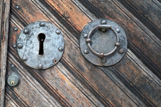 Old door with lock. Solid wood. Close up.