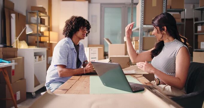 Business people, laptop or logistics with discussion for distribution, delivery or supply chain. Businessman, woman or colleagues with computer or boxes for conversation, freight chat or shipping