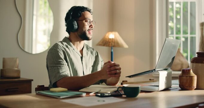 Businessman, laptop and video call with headphones for online meeting or communication in home. Man, freelancer or remote work with discussion, computer or webinar for proposal or conversation