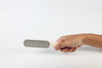 hand holding foot file tool isolated on white background