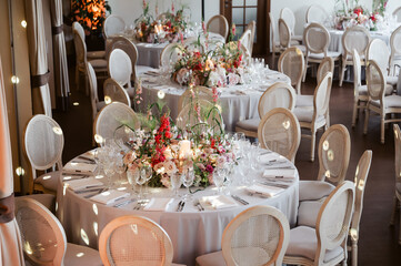 Elegant wedding reception hall with round tables, floral centerpieces, soft lighting, and refined décor—luxury event setup perfect for celebrations, banquets, and sophisticated gatherings.