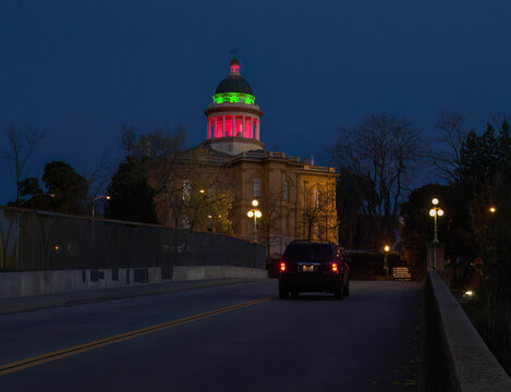 Auburn, CA U.S.A. - Dec. 2024: Auburn&rsquo;s historic courthouse shines in green and red holiday lights, seen at night from the Maple Street Bridge.