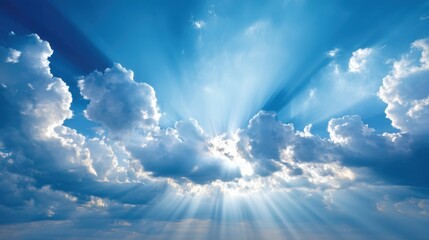 Bright Sun Rays Breaking Through White Clouds in a Beautiful Blue Sky with a Dramatic Sunrise or Sunset Atmosphere Captured in Nature