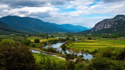 Serene River Flowing Through Lush Green Valleys Surrounded by Majestic Mountains Under Cloudy Sky with Light Shadows and Vibrant Landscapes