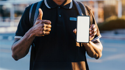 Digital thumbs up and cellphone: A man presents his blank cellphone screen while offering a thumbs-up, blending modern communication with a gesture of approval.
