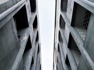 Urban concrete structures forming a narrow gap with geometric patterns.