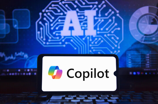 Microsoft Copilot artificial intelligence logo is displayed on a smartphone screen, with a blue AI technological background.