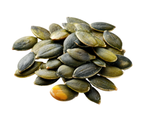 Pile of glossy green pumpkin seeds, some with light yellow