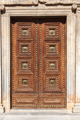 Historic wooden door of the Palace of Charles V in Granada, Spain