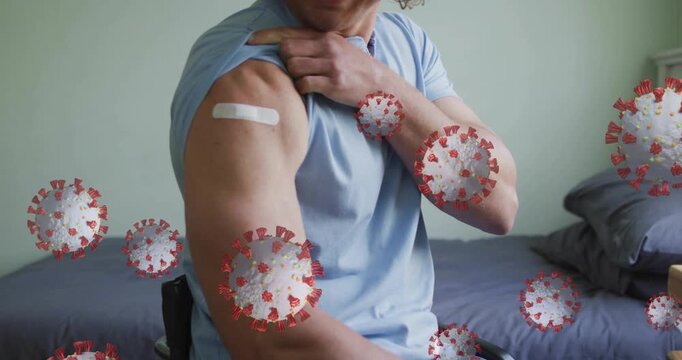 Man pulling up sleeve and showing bandage, virus icons growing over arm, highlighting vaccination