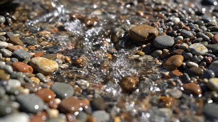 Gentle stream flows over smooth, colorful pebbles on a sunny day, creating a serene and natural motion scene for relaxation and mindfulness content. - Powered by Adobe