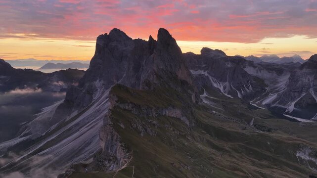 Cinematic aerial video of spectacular sunrise at the Seceda mountain ridge line in the Italian Dolomites