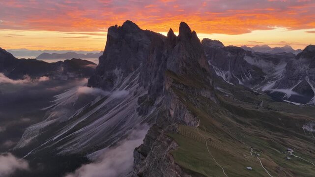 Cinematic aerial video of spectacular sunrise at the Seceda mountain ridge line in the Italian Dolomites